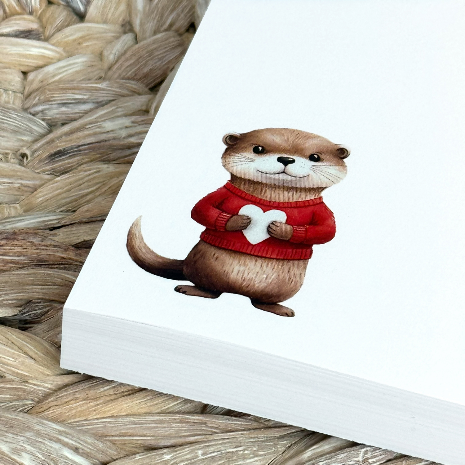 notepad with watercolor otter in red sweater holding white heart
