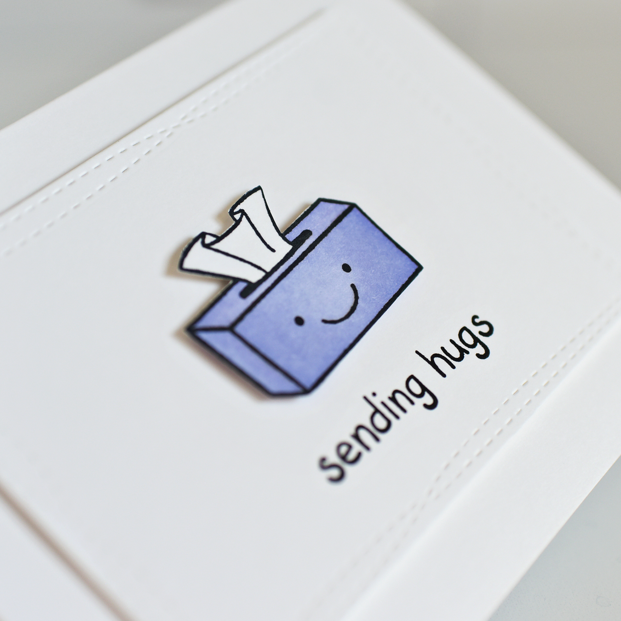 smiling tissue box on a sending hugs card