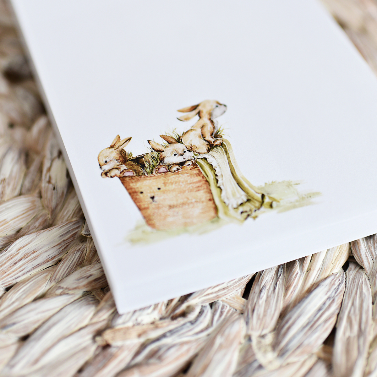 basket of baby bunnies printed on a white notepad